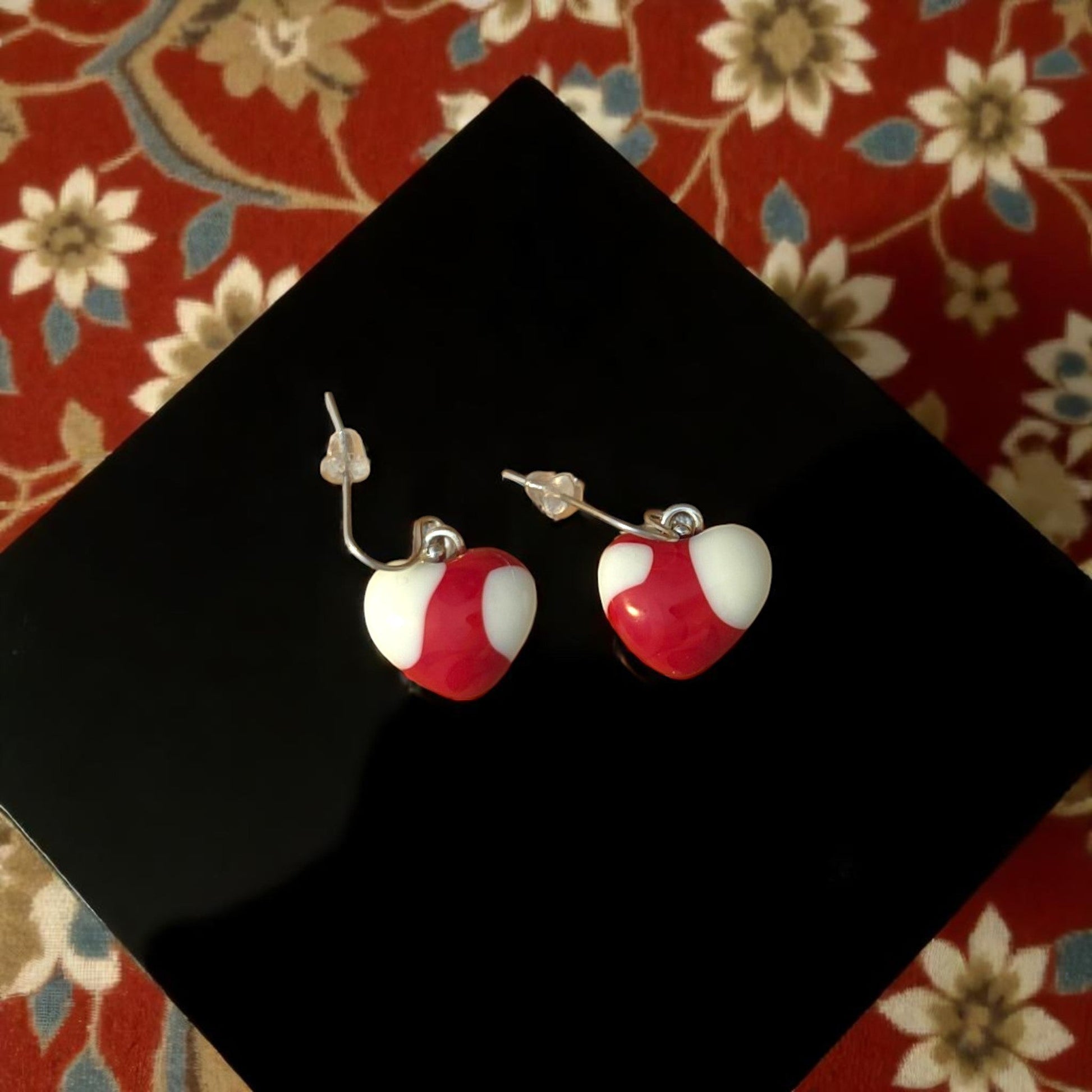 Heart Earrings made of Fused Glass in Red and White on black pillow